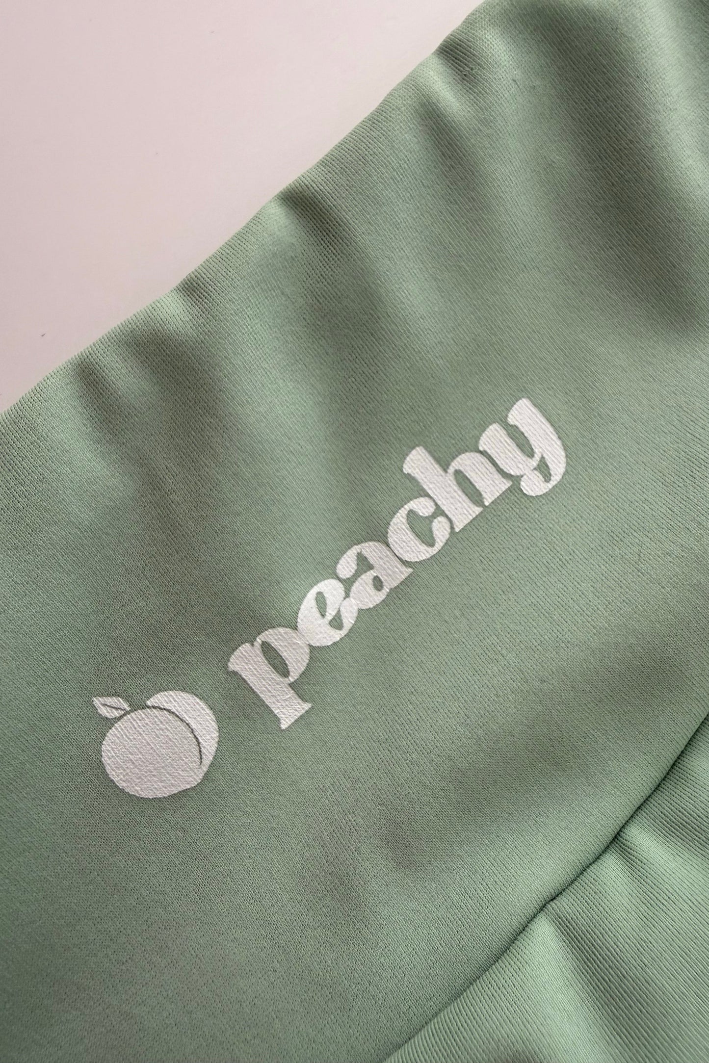 Green fabric with 'peachy' logo